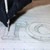 A lifestyle image of an Excel Large Tracing Wheel in use on paper.