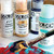 A lifestyle image of Golden Fluid Acrylics in use. 