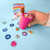 A lifestyle image of a House Of Marbles Rainbow Sticker Stamper in use.
