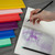 A lifestyle image of Itoya ProFolio Oasis Light Notebooks in use.